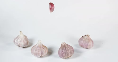 Garlic Heads and Clove Resting on White