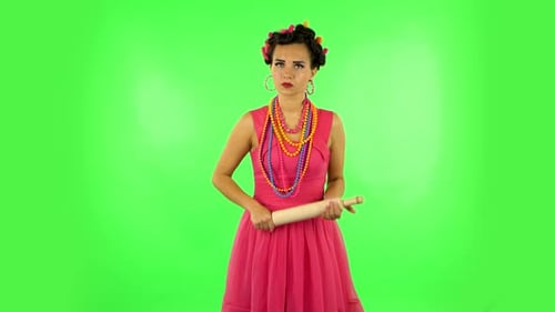 Woman in Pink Dress Brandishing Rolling Pin
