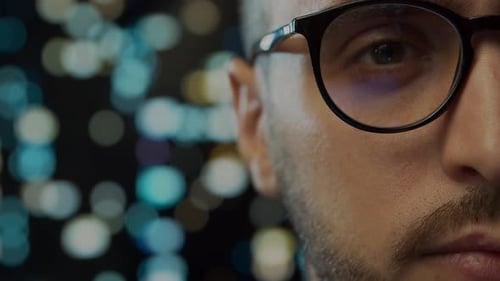 Close-up portrait of a young man working at the computer.