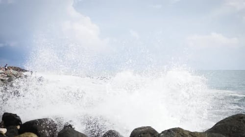 Vorderansicht von Meereswellen, die auf Felsen brechen. Rock mit den großen Steinen im Meer und Wellen mit Schaum.