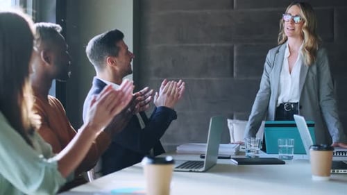 Team Applauds Colleague's Presentation in Modern Office
