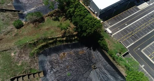 aerial video of sewage treatment plants, residential retention ponds around green area in residentia