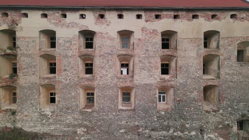 Drone Flies Over Medieval Castle on Mountain in Small European City at Cloudy Autumn Day