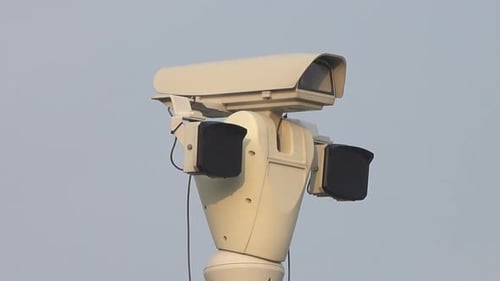 Rotating Security Camera Under Clear Blue Sky