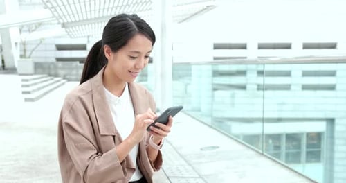 Young Woman Using Smartphone in Urban Environment