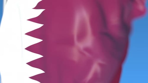 Realistic Qatar Flag Waving Against Blue Sky