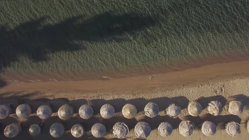 Aerial Vacation Scene of Sea and Beach with Straw Umbrellas
