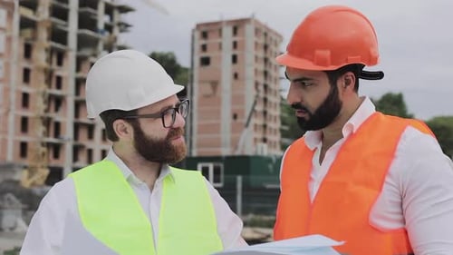 Building a Residential Complex or Business Center. Team of Engineers Men Analyze Plans Construction