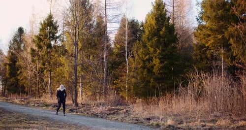 Female Tourist Walking on a Trail in Mountains
