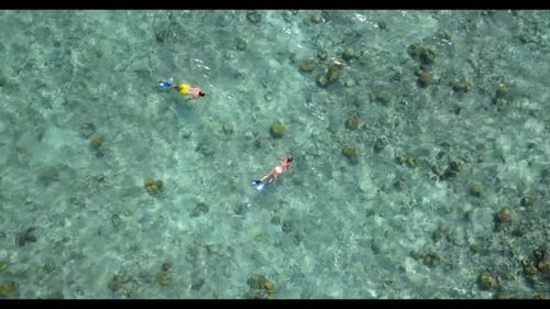 Romantic couple in love on paradise shore beach trip by blue green lagoon with clean sandy backgroun