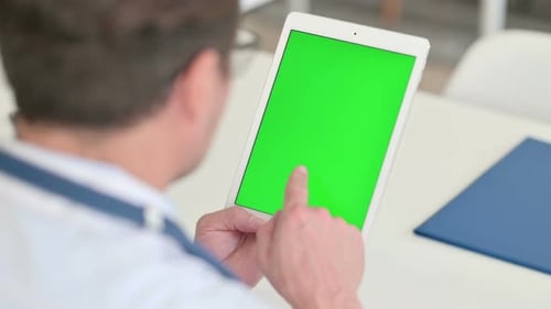 Doctor Using Tablet with Green Screen Display
