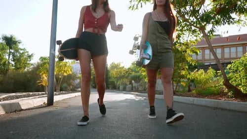 Girlfriend Girls Go To the Park Holding Skateboards in Their Hands Talking and Laughing, Smiling at