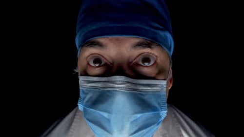 Close Up of Doctor Wearing Surgical Mask and Cap
