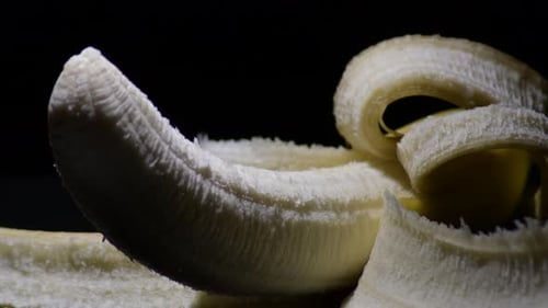 Banana Fruit Peeled Gyrating with Black Background