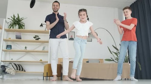 Father and Children Dancing in Living Room