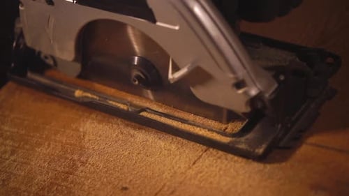 Working Disk Saw Is Sawing Wooden Board, Close Up in Carpentry