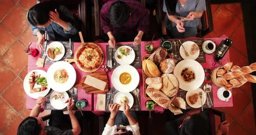 Overhead Shot: Friends Enjoying Delicious Italian Feast