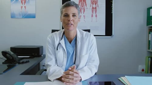 Friendly Female Doctor Explains Healthcare at Her Desk