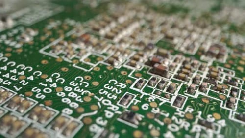 Extreme Closeup of Green Printed Circuit Board Electronics Shot with Dolly