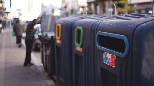 Man Disposing of Garbage in Waste Separating Bins