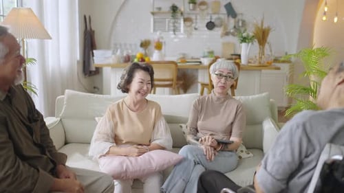 Senior Friends Laughing Together in Bright Home Interior
