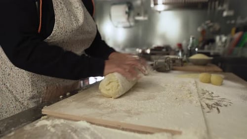 Close up female hands kneading the dough preparing fresh homemade pasta