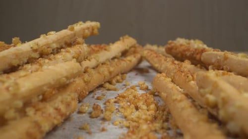 Golden Breadsticks on Wooden Surface