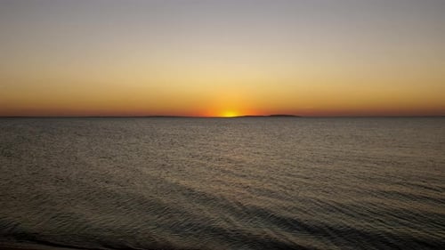 Sunset. The Bright Sun Sets Over the Horizon in the Sea.