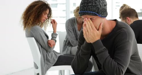 Man Crying in Group Therapy Session