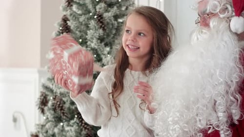 Girl Receives Christmas Gift from Santa Claus