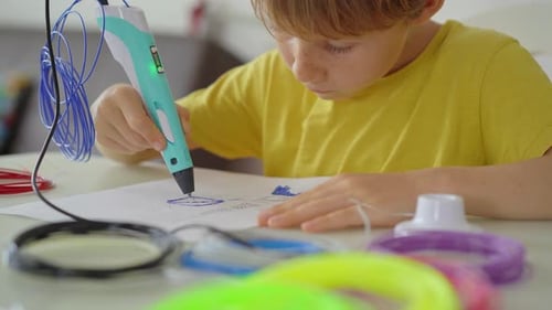 Close Up Shot of a Little Boy That is Using a 3d Pen