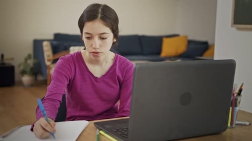 Teen Using Laptop for Online Learning at Home