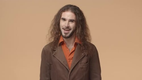 Young Adult With Long Hair Talks to Camera