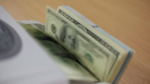 Automatic Money Counter Counts Stacks of Dollars