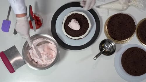Pastry Chef Preparing Decadent Layer Cake Overhead Shot