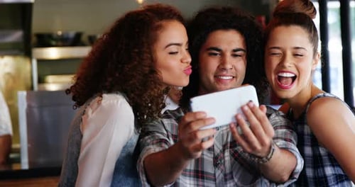 Friends Laughing and Looking at Cellphone Together