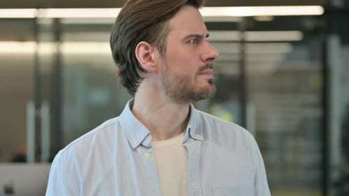 Impatient Man Glancing at His Watch in Office