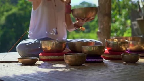 Woman Performs Sound Healing with Singing Bowls