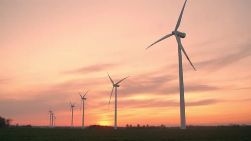 Scenic Wind Turbines Turning at Vibrant Sunset