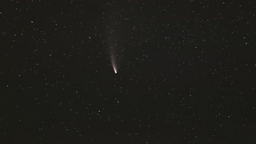 Comet Streaking Through the Starry Night Sky