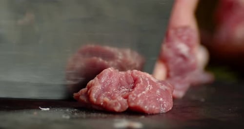 Close Up Chopping Raw Meat on Board