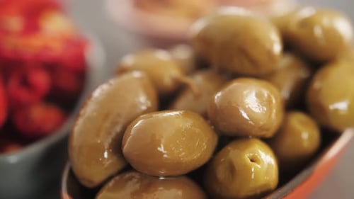 Close Up Shot of Marinated Green Olives in a Bowl