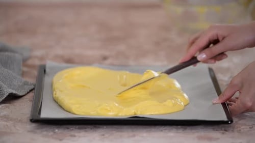 Spreading the Dough for the Sweet Roll on a Baking Sheet