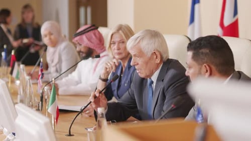 Adults Sitting at a Conference Table at Meeting