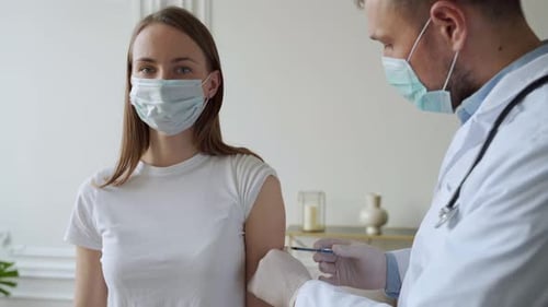 Doctor Gives Injection to Woman in Hospital Setting