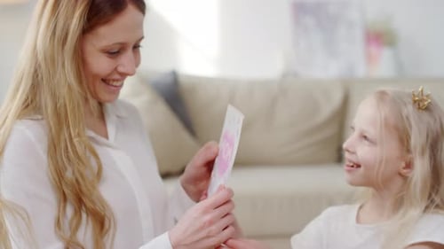 Daughter Gives Mother Handmade Card on Birthday