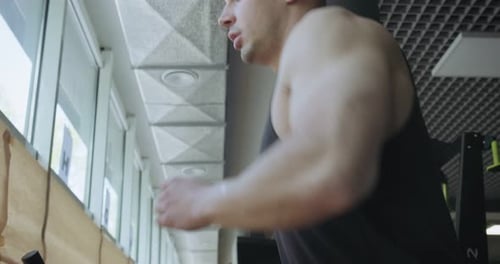 Man Running on Treadmill in Gym. Men Doing Difficult Cardio Workout with Air Runner
