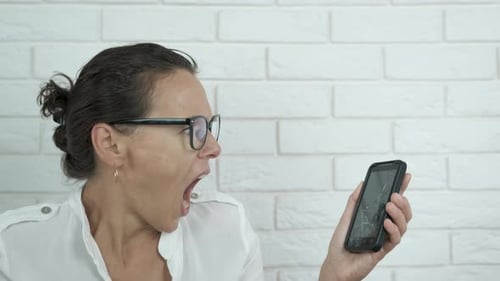 Woman Yelling at a Broken Phone
