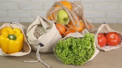 Produce in Reusable Grocery Bags on Table
