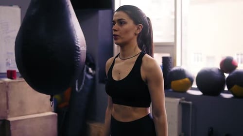 Young Woman Lifting Weights at the Gym
